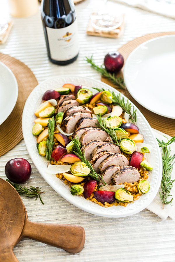 Enjoy the flavors of fall with this grilled pork loin, served over a bed of farro with roasted harvest vegetables and ripe plums.
