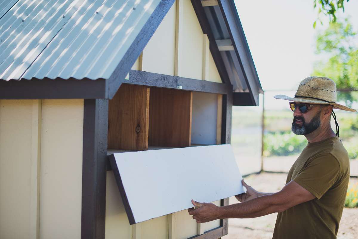 Farmer T showing off the new chicken coop at Kendall-Jackson gardens.