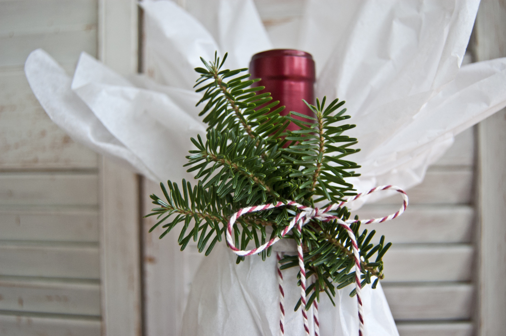 With just a touch of tissue, a twist of twine and a few sprigs of rosemary or evergreen, this bottle is ready for a classy affair.
