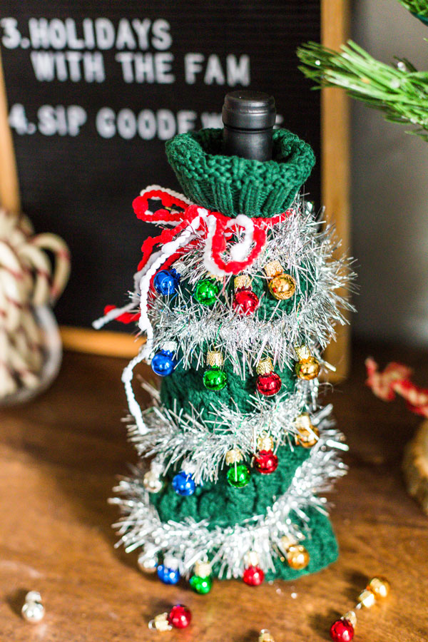 Heading to a fun, festive holiday party this year? Give the gift of a bottle of wine and dress it up with this Ugly Christmas Sweater for a Wine Bottle DIY.