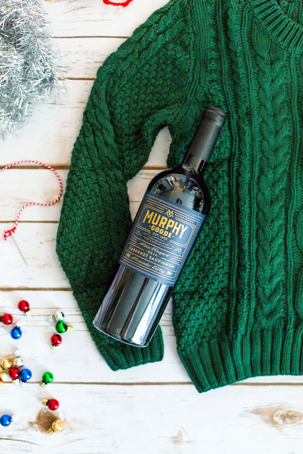 Heading to a fun, festive holiday party this year? Give the gift of a bottle of wine and dress it up with this Ugly Christmas Sweater for a Wine Bottle DIY.